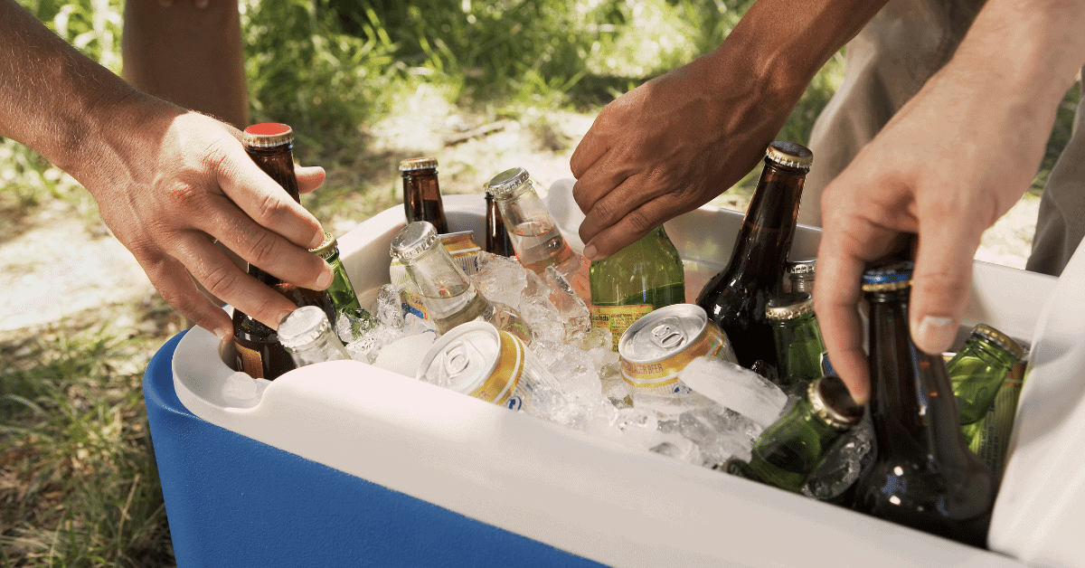 people grabbing cold drinks from a cooler