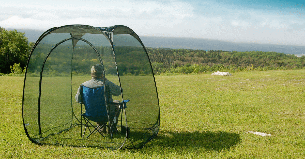 a person sitting inside a small screen house