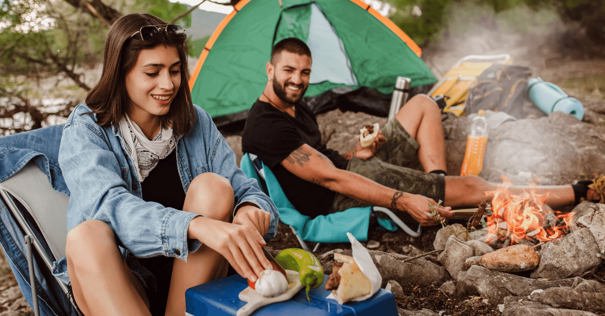 couple cooking on the campfire