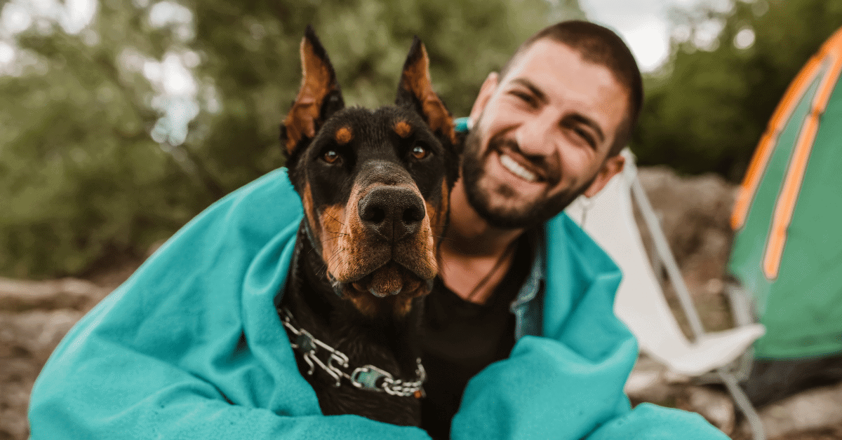 man camping with dog