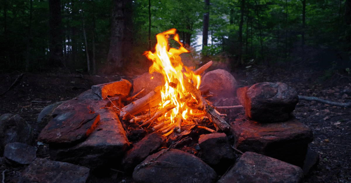 a campfire burning in the woods