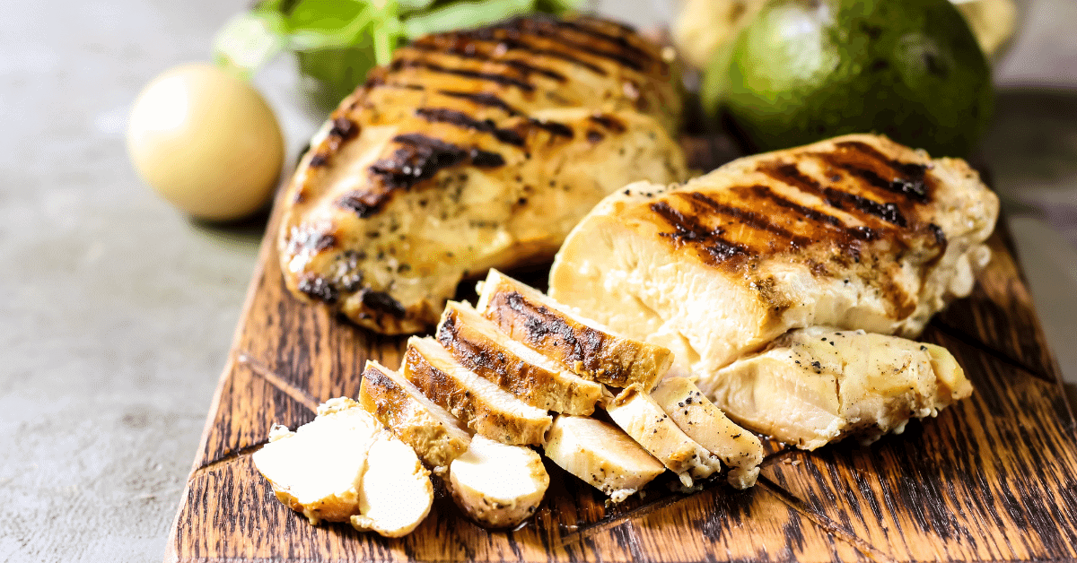 cooked chicken breast on a chopping board