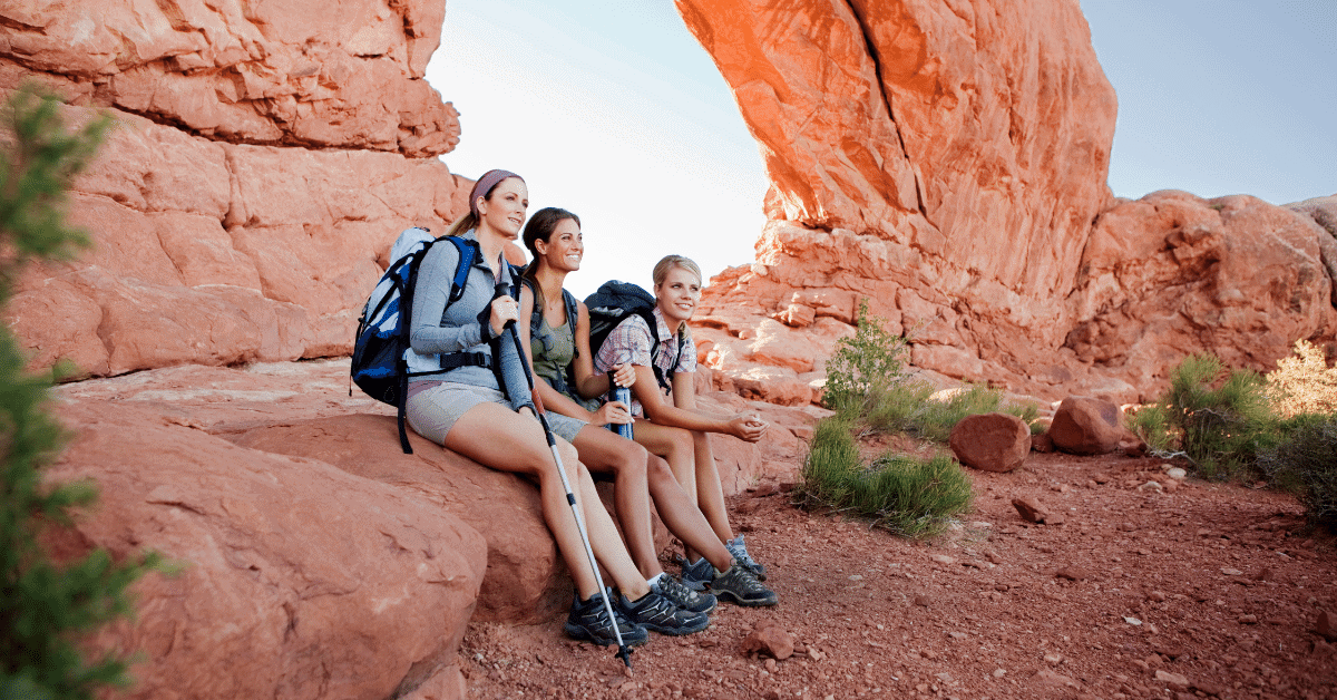 3 girls taking a rest on a hike