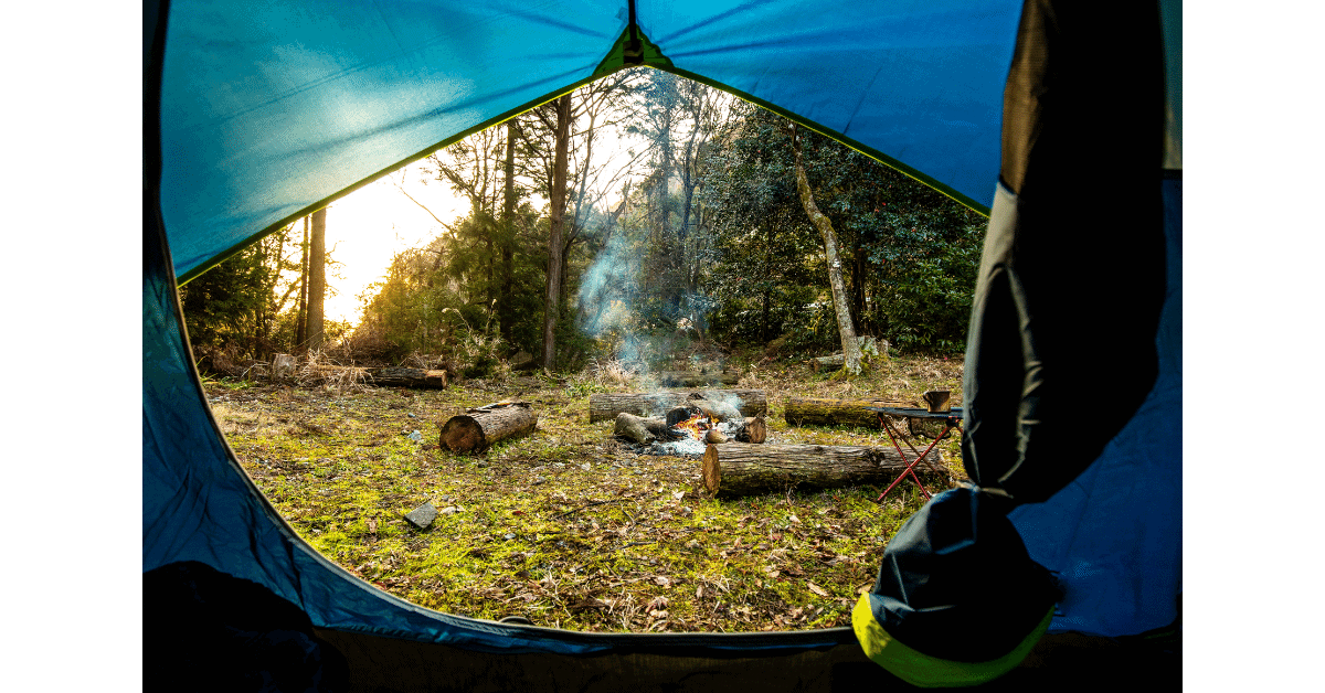 view of a campfire from inside a tent