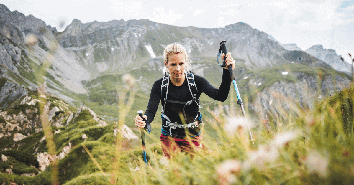 woman hiking with trekking poles
