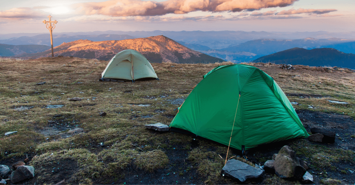 2 dome tents on a mountain top2 dome tents on a mountain top