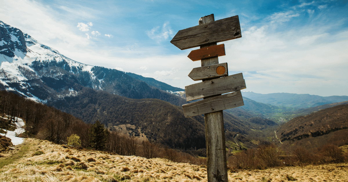 a sign post on a hiking trail