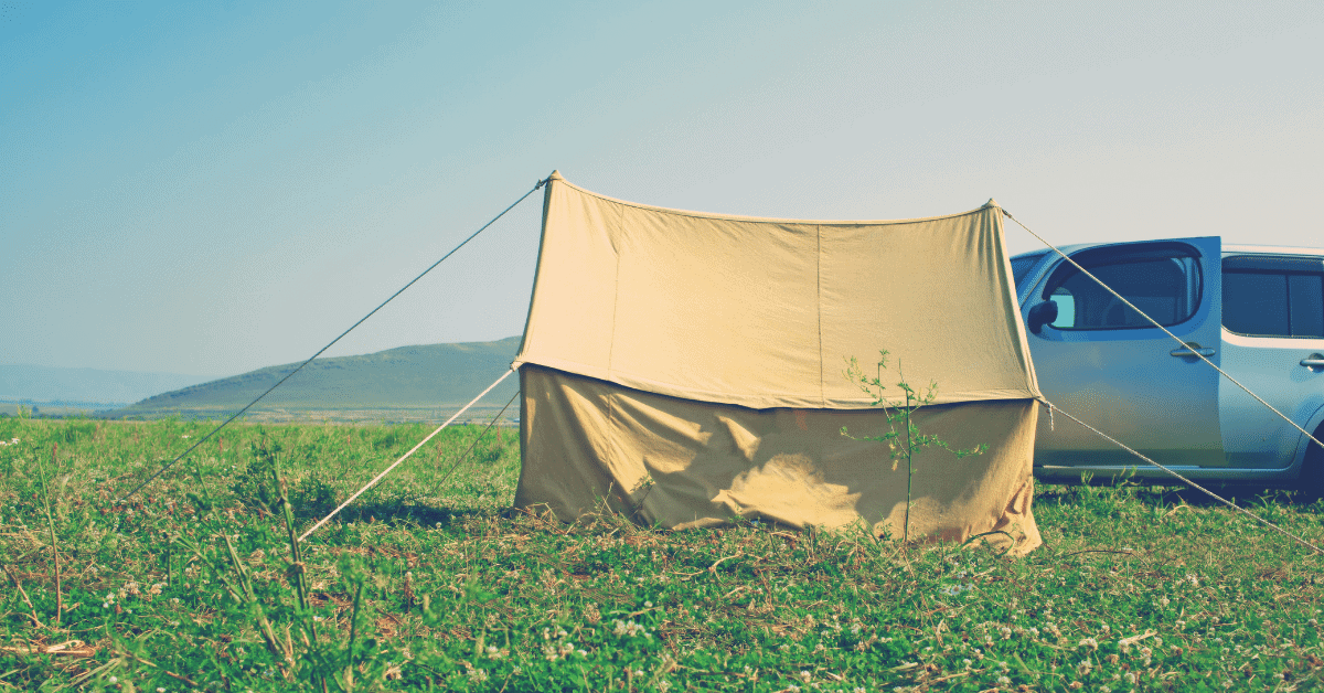 a canvas tent in a field