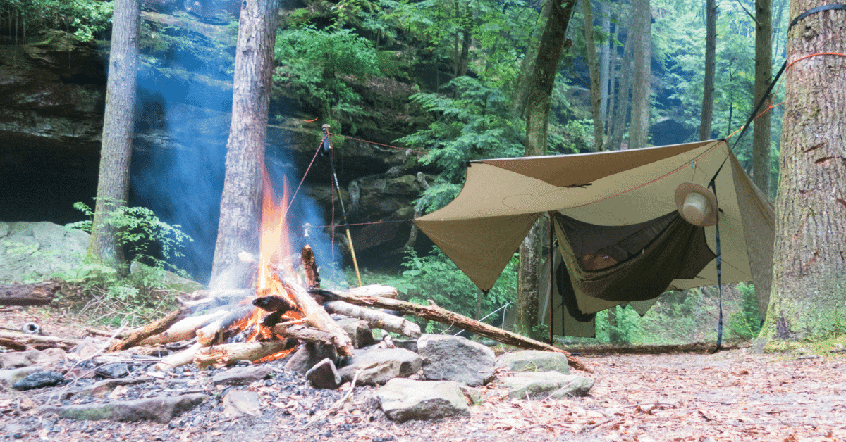 a hammock with a bug net and hammock tarp over it