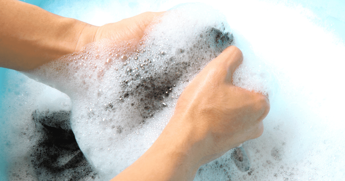 a person hand washing a hammock