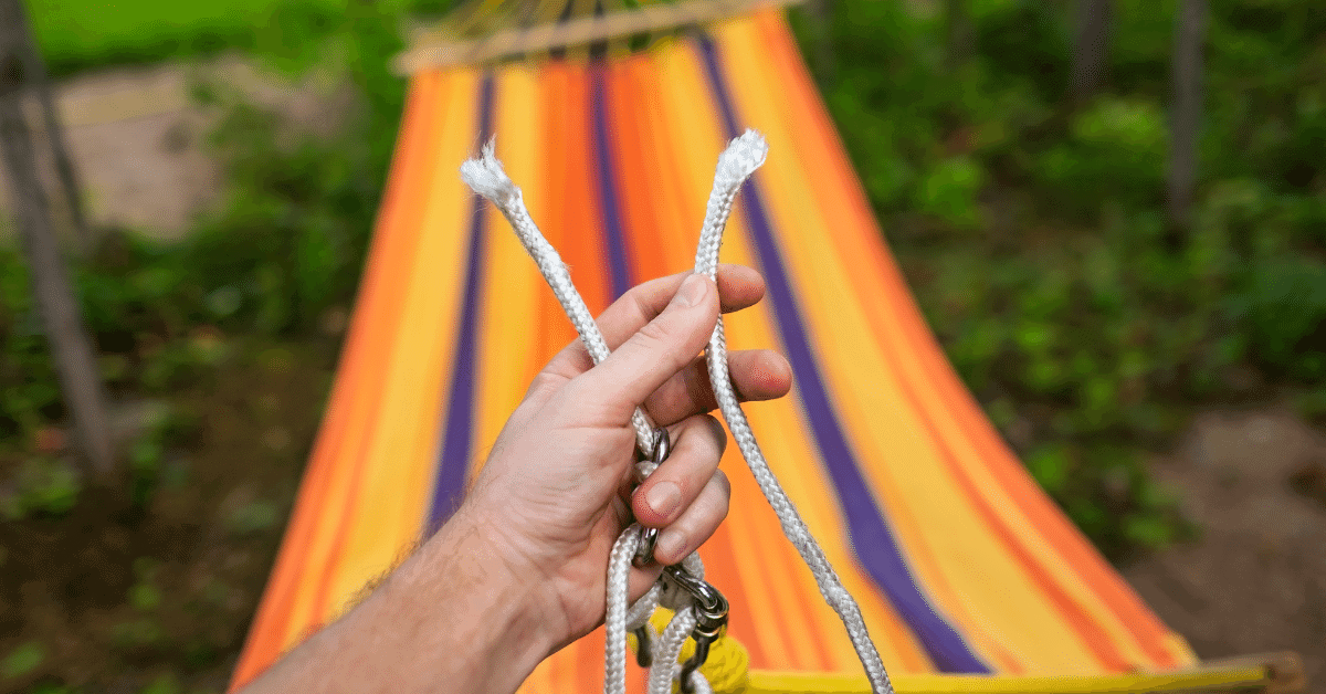 a person holding a snapped hammock rope