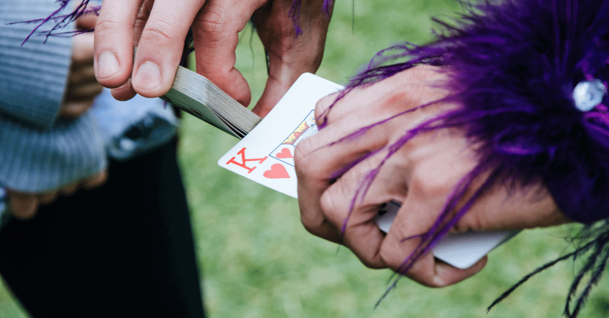 a person shuffling a deck of cards with the king on top