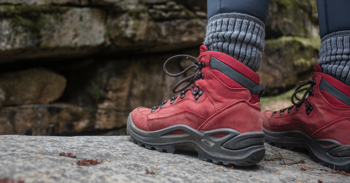 a person wearing red hiking shoes with thick socks