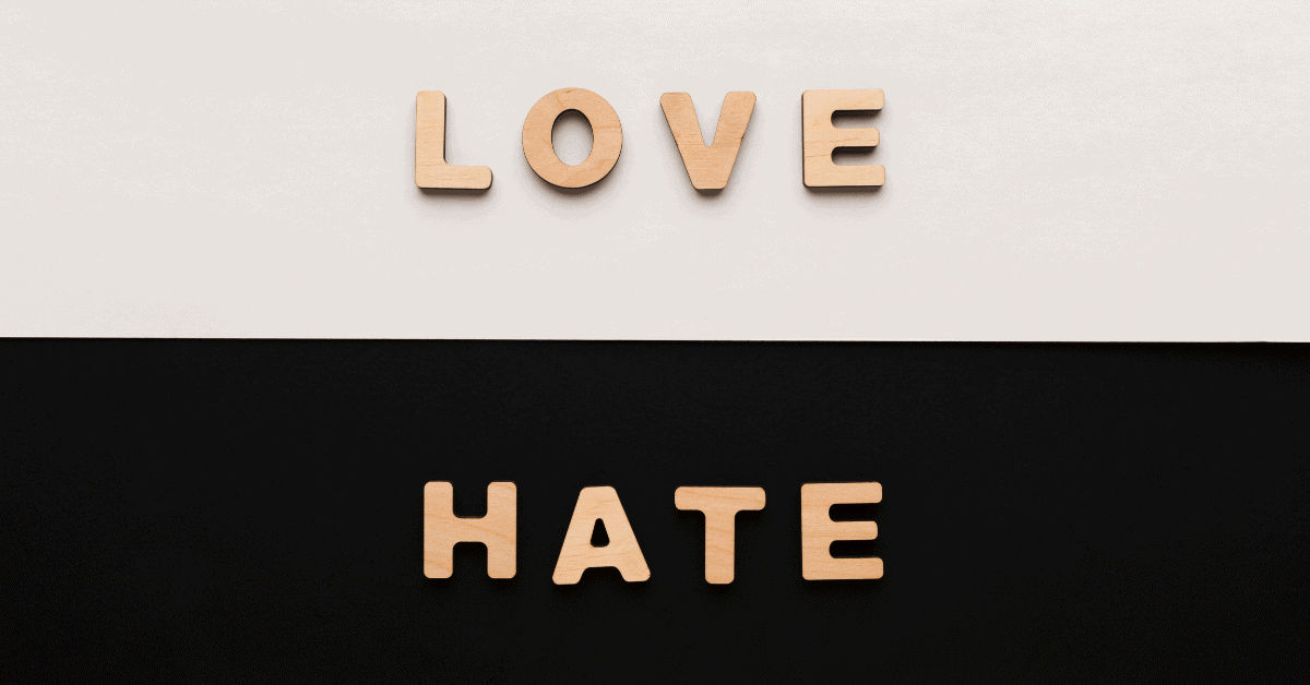 love and hate in little wooden letters on a black and white background