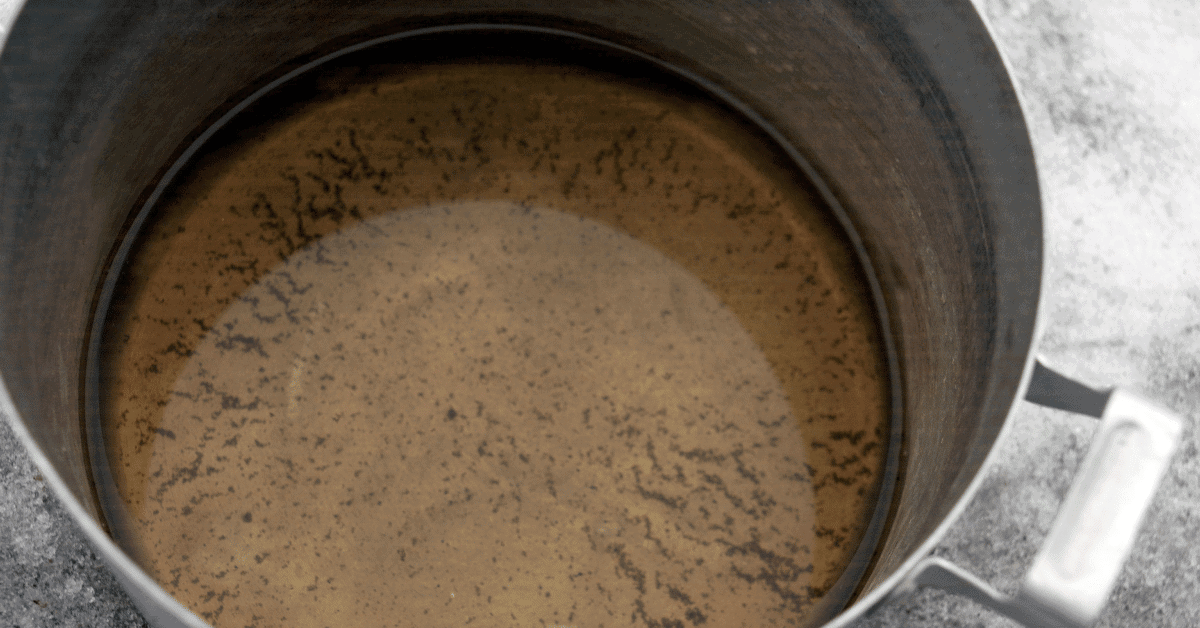 water in a pot with visible sediment on the bottomwater in a pot with visible sediment on the bottom