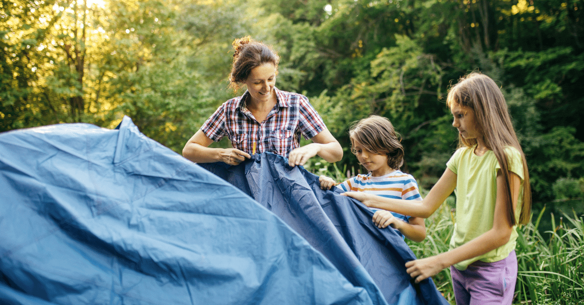 a family setting up a tent