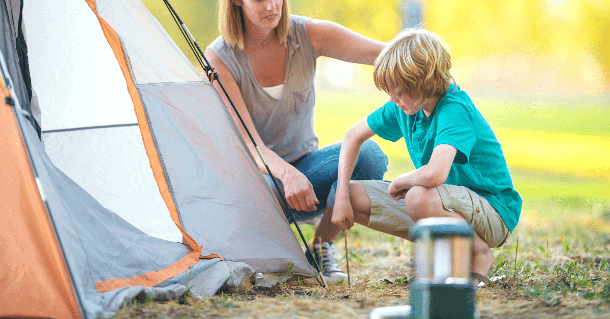 a mother and son staking a tent together