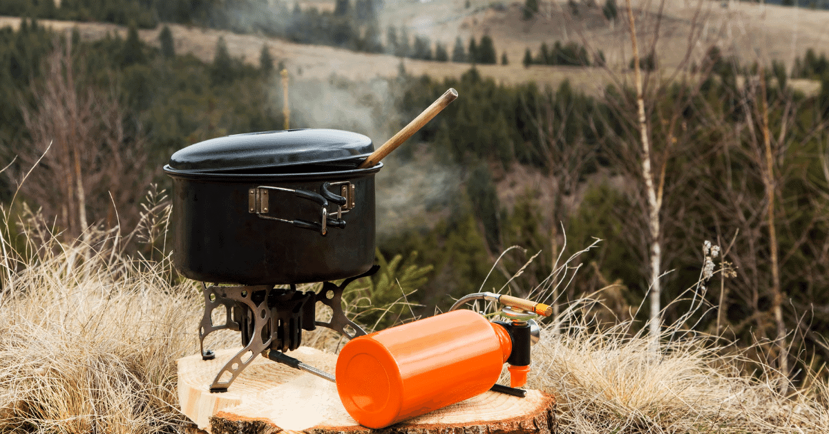 a pot on a camping stove in the wild