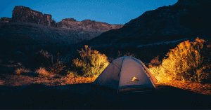 a tent in the desert at nighttime