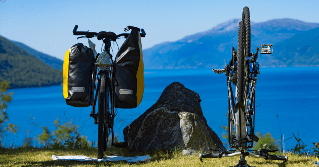 two bike camping bicycles by a lake