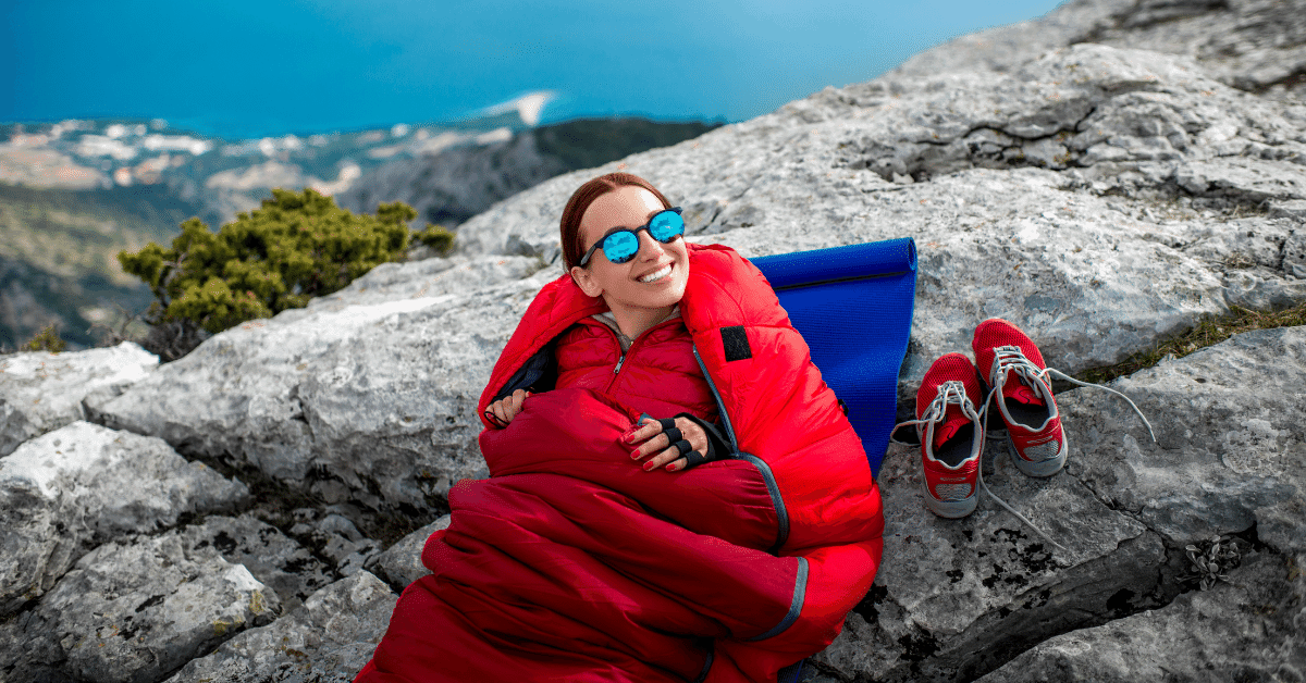 girl wearing sunglasses in a red sleeping bag