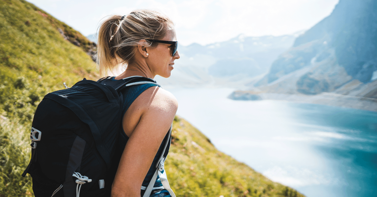 hiker in the mountains by a lake