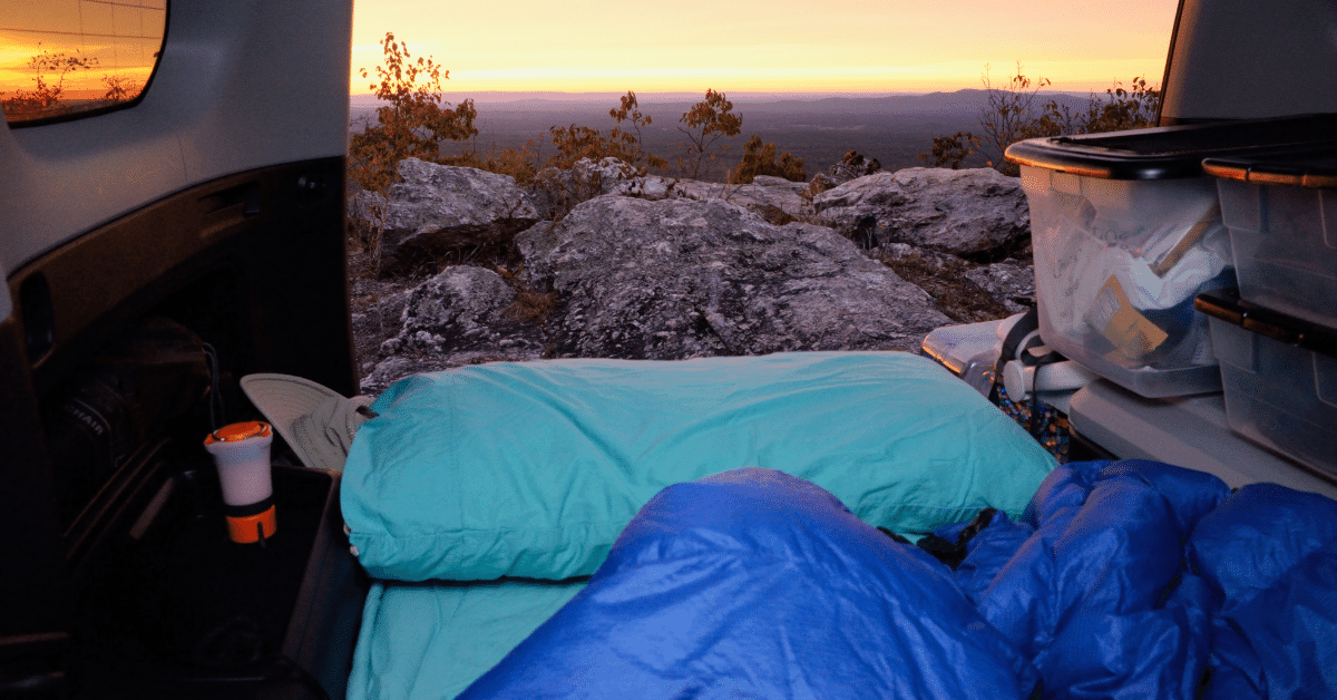 sleeping bag on a bed in the back of a car