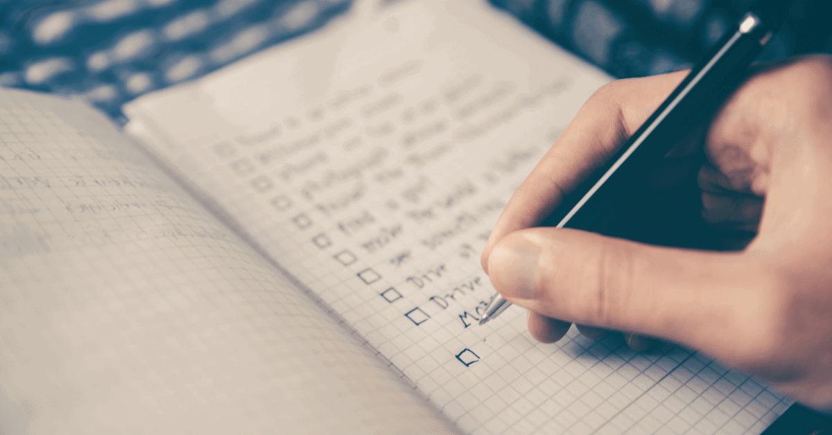 person writing a checklist