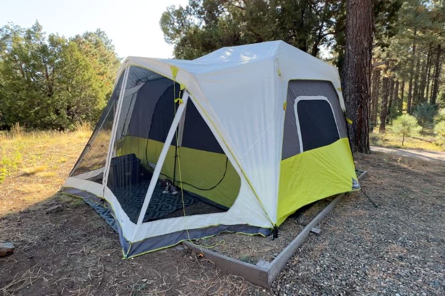 The CORE 10 Person Instant Cabin Tent with Screen Room at a campsite